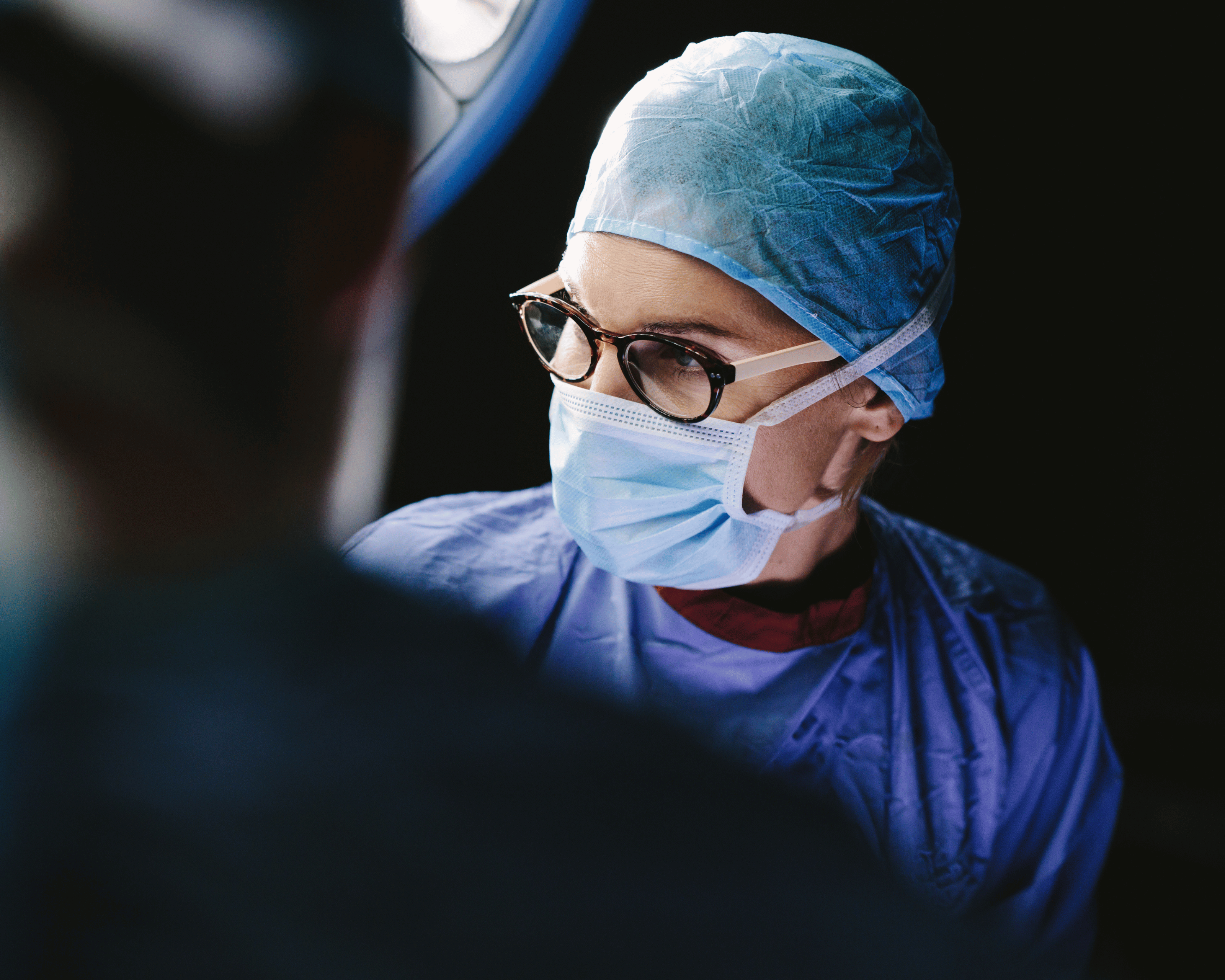 Nurse in surgery wearing glasses and mask